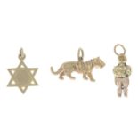 Six charms.One with hallmarks for 14ct gold, length 1.8cms, 3gms.