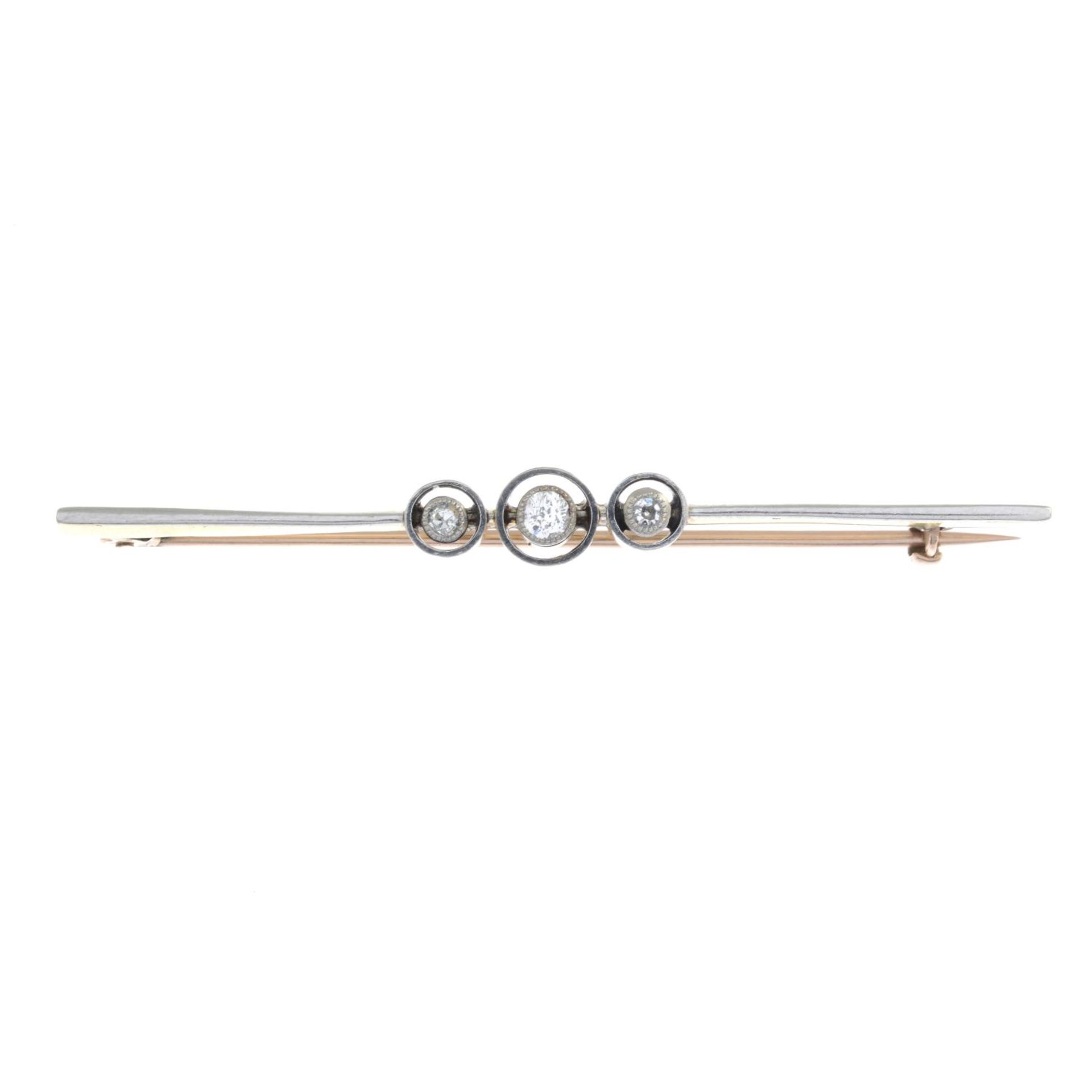 An early 20th century gold diamond bar brooch.Estimated total diamond weight 0.15ct.