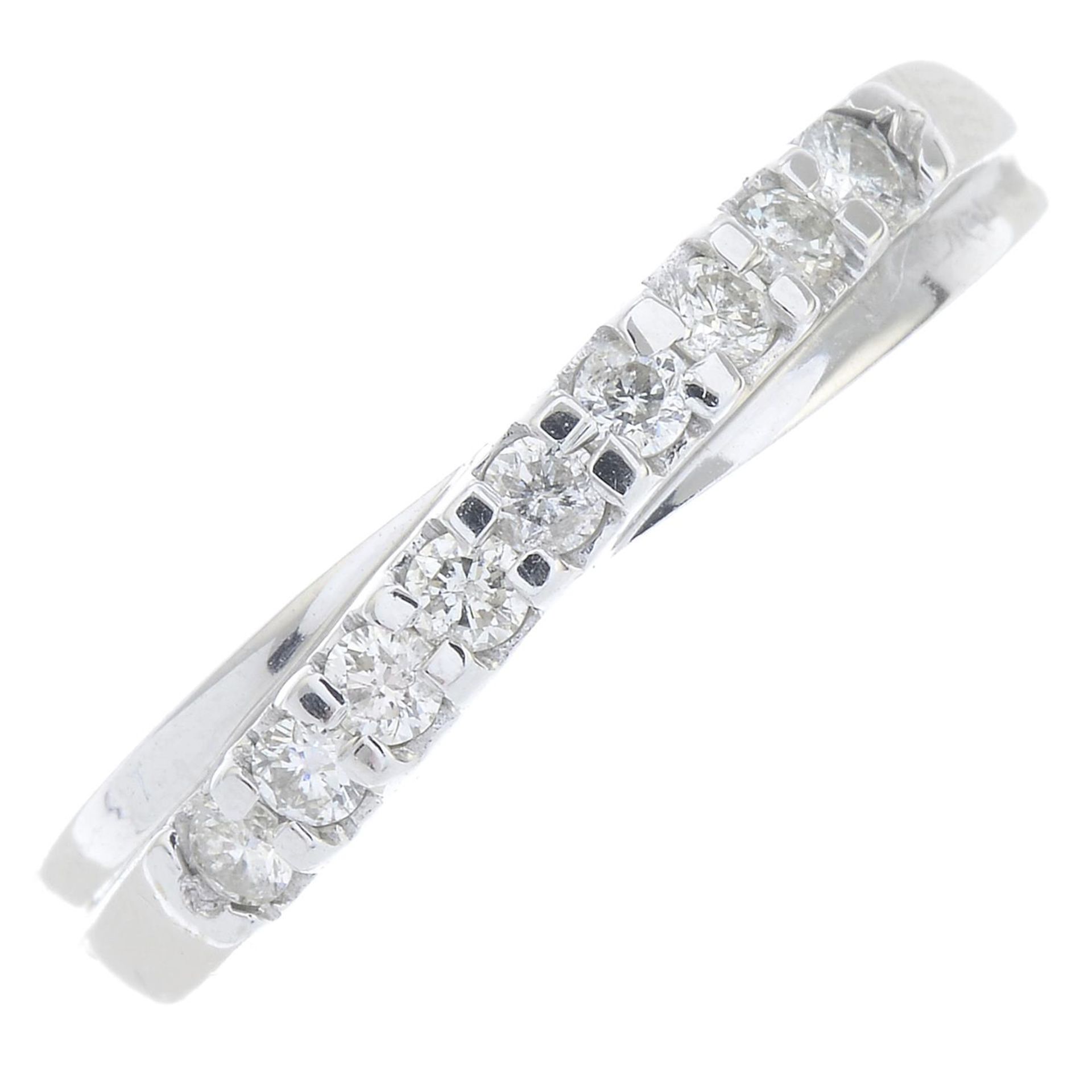 An 18ct gold diamond nine-stone ring.Total diamond weight 0.25ct, stamped to band.