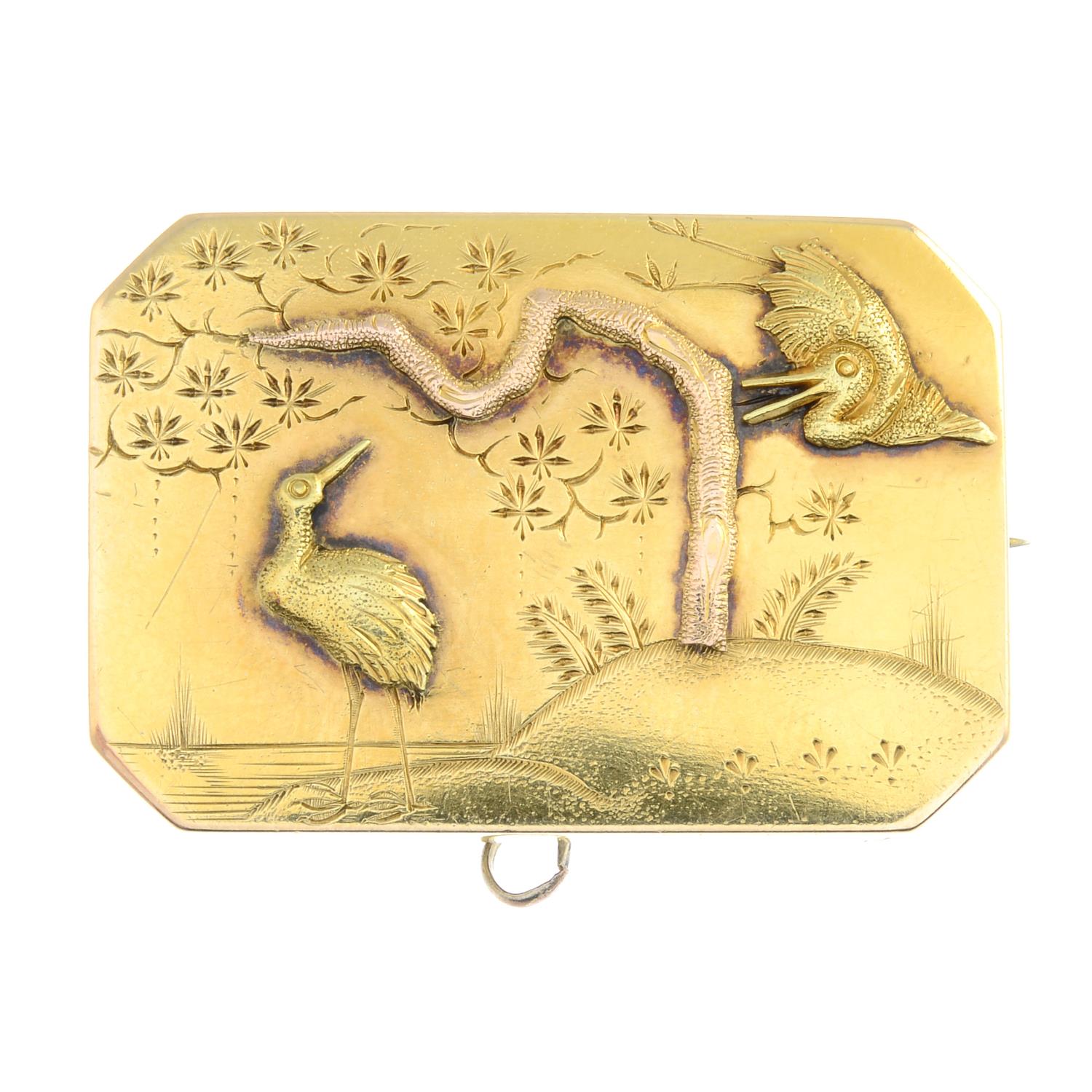 A Victorian gold brooch, designed to depict two cranes in a landscape.