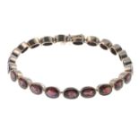 A 9ct gold garnet bracelet.Hallmarks for 9ct gold.