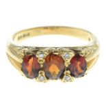An 18ct gold garnet and diamond ring.Hallmarks for 18ct gold.