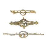 Four early 20th century 9ct gold bar brooches, and a 9ct gold Welsh dragon tie-pin.