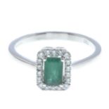 An 18ct gold emerald and diamond cluster ring.Emerald weight 0.52ct.