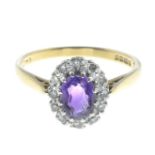 An 18ct gold amethyst and diamond cluster ring.Estimated total diamond weight 0.10ct.