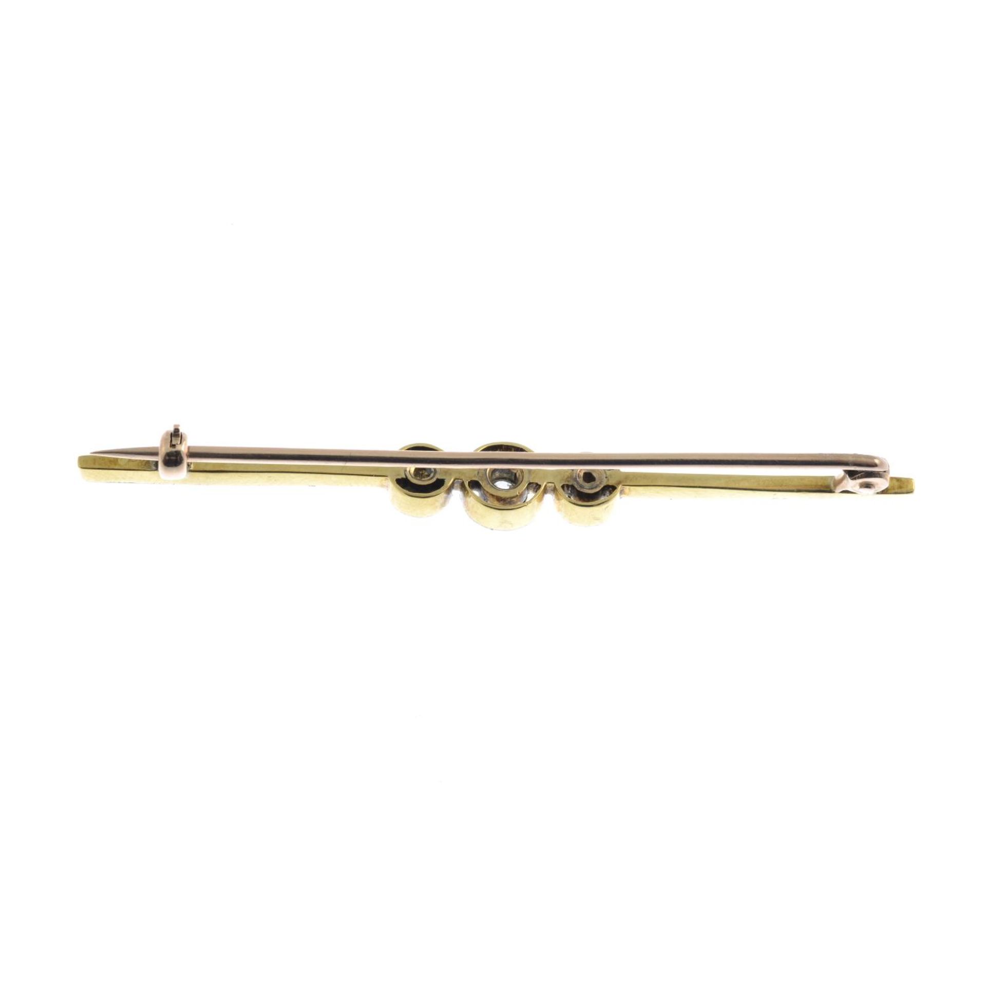 An early 20th century gold diamond bar brooch.Estimated total diamond weight 0.15ct. - Image 2 of 2