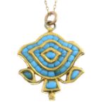 A turquoise pendant, depicting a flower, with chain.Chain marked K14.