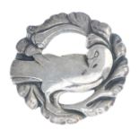 A brooch, designed as a dove with foliate surround,