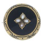 A late Victorian gold split pearl, enamel and onyx mourning brooch.