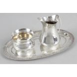 A modern silver strawberry set comprising oval tray, cream jug and sugar bowl.