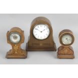Four Edwardian mantel clocks, each with inlaid decoration to cases, the largest 9 (23cm) tall.