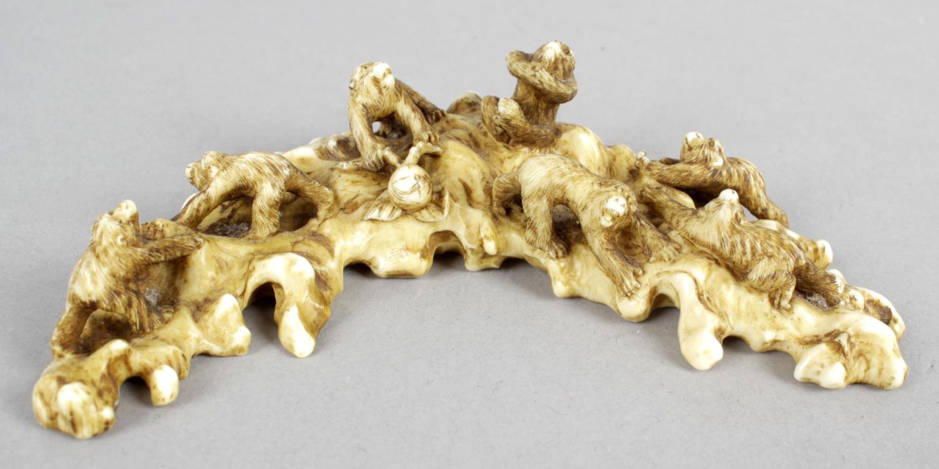 A 19th century carved section of ivory modelled as a group of seven monkeys,