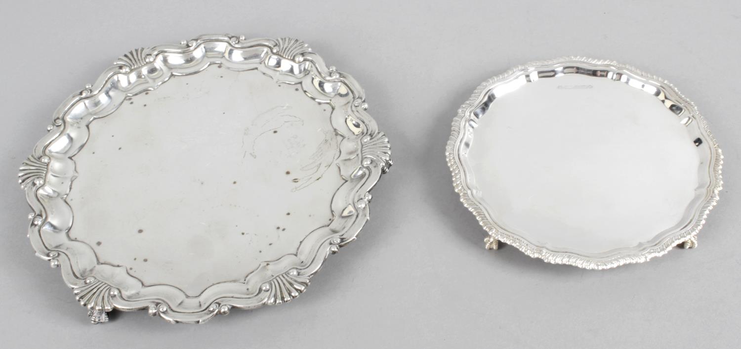 Two silver card trays - a Victorian card tray with shaped border with shell motif standing on three