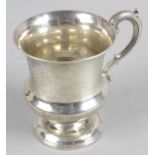 A Georgian silver christening mug of urn shape with acanthus scrolling handle.