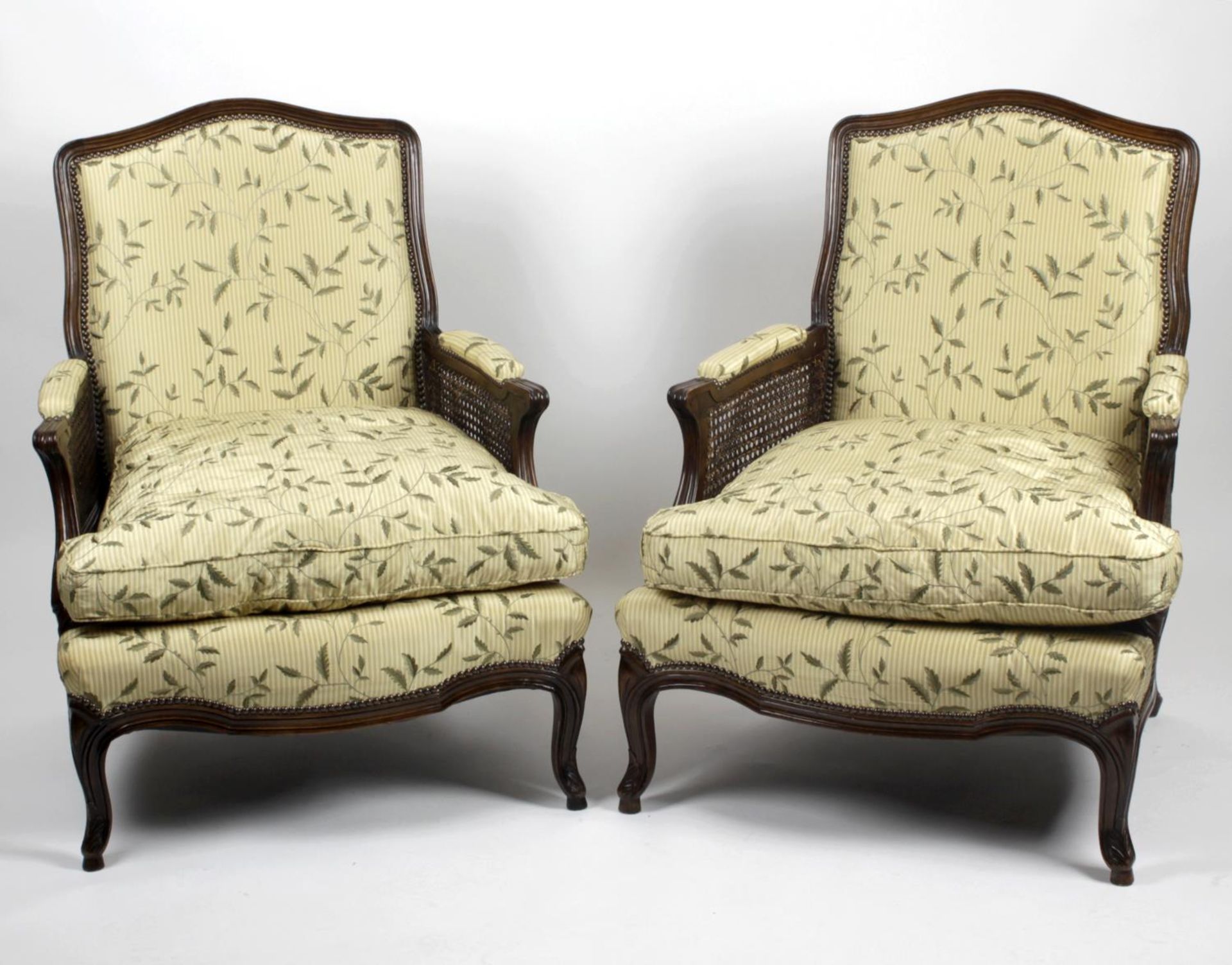 A pair of Louis XV style stained beech framed armchairs,