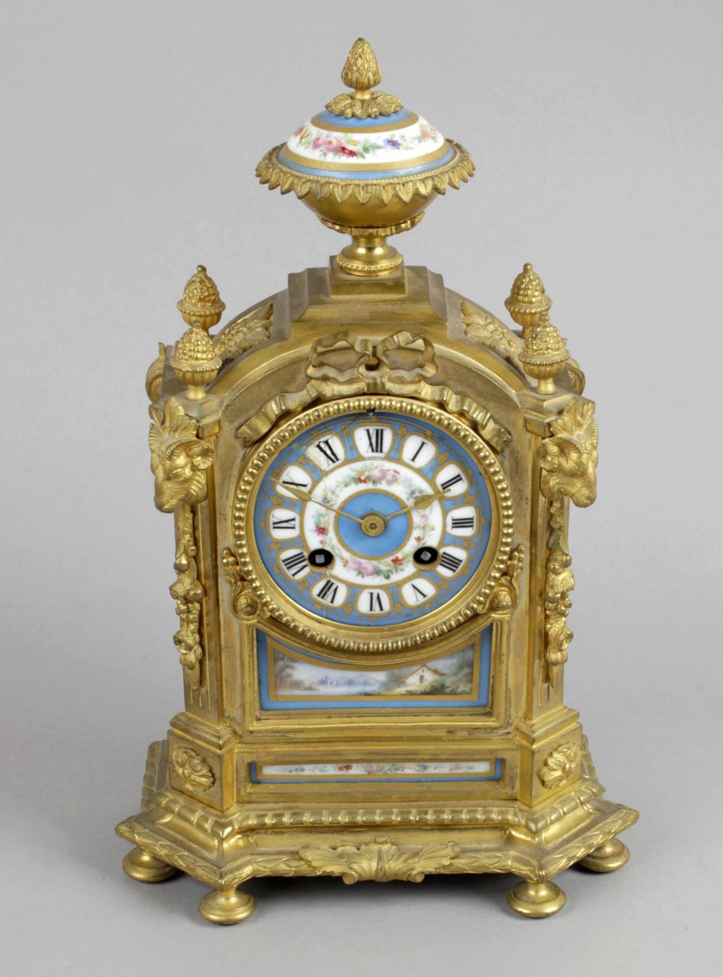 A small 19th century gilt bronze and porcelain mantel clock,