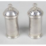 A modern pair of silver salt and pepper pots by the Guild of Handicraft,