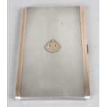 A mid-20th century silver cigarette case with rose coloured banding and engine turned decoration