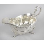 A late George III silver sauce boat,