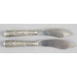 A pair of Chinese export silver butter knives,