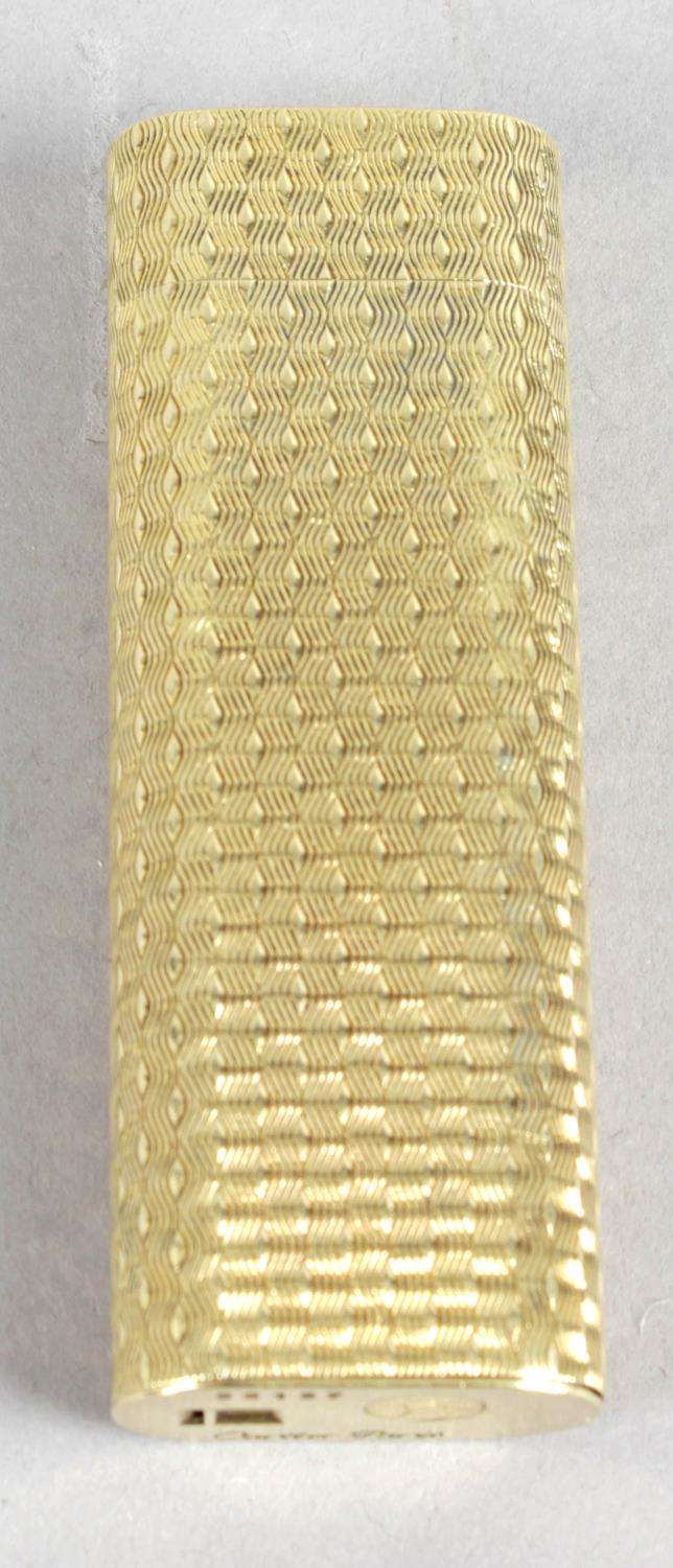 A gold Cartier cigarette lighter,