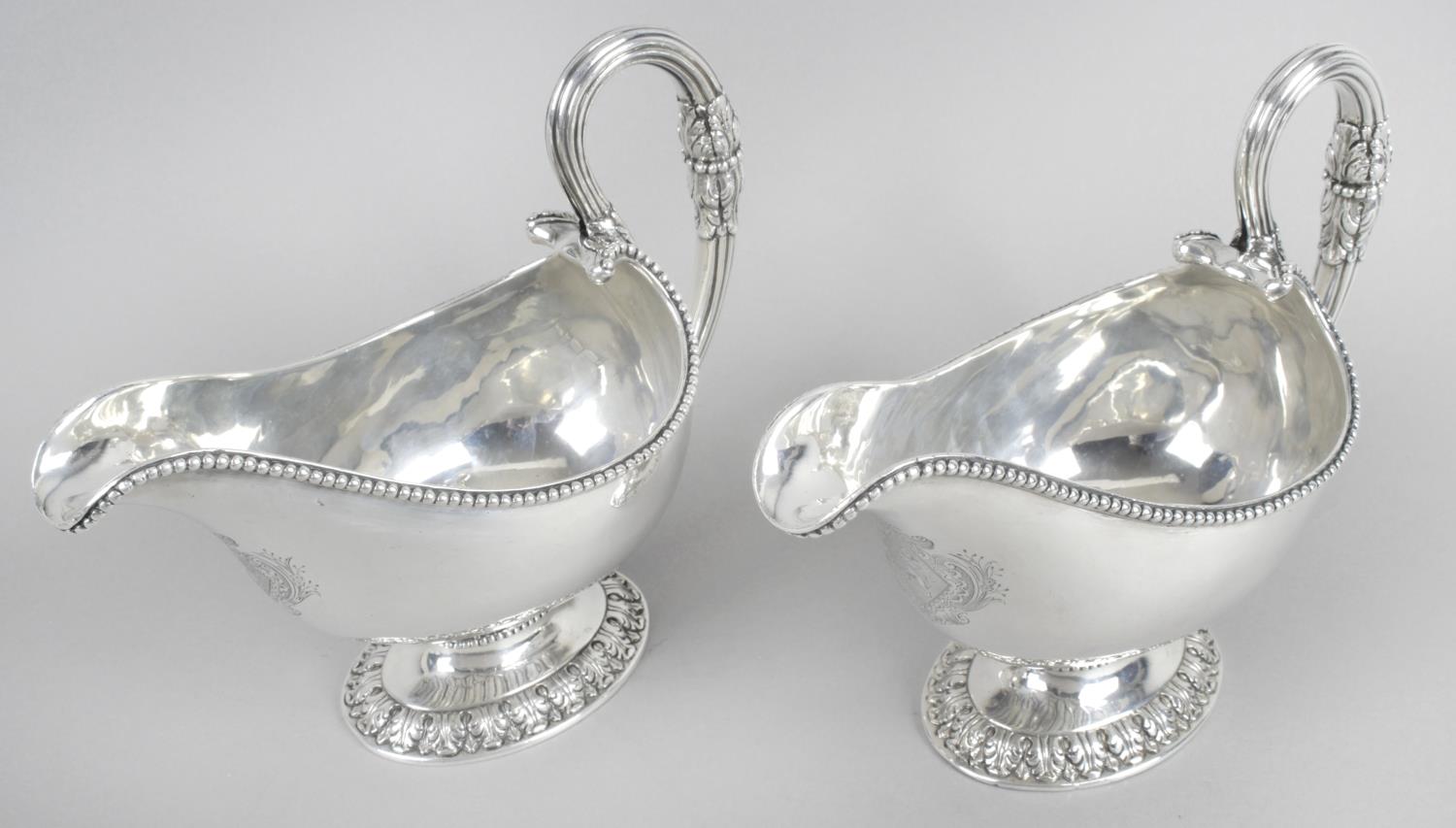 An impressive pair of George III Irish silver pedestal sauce boats,