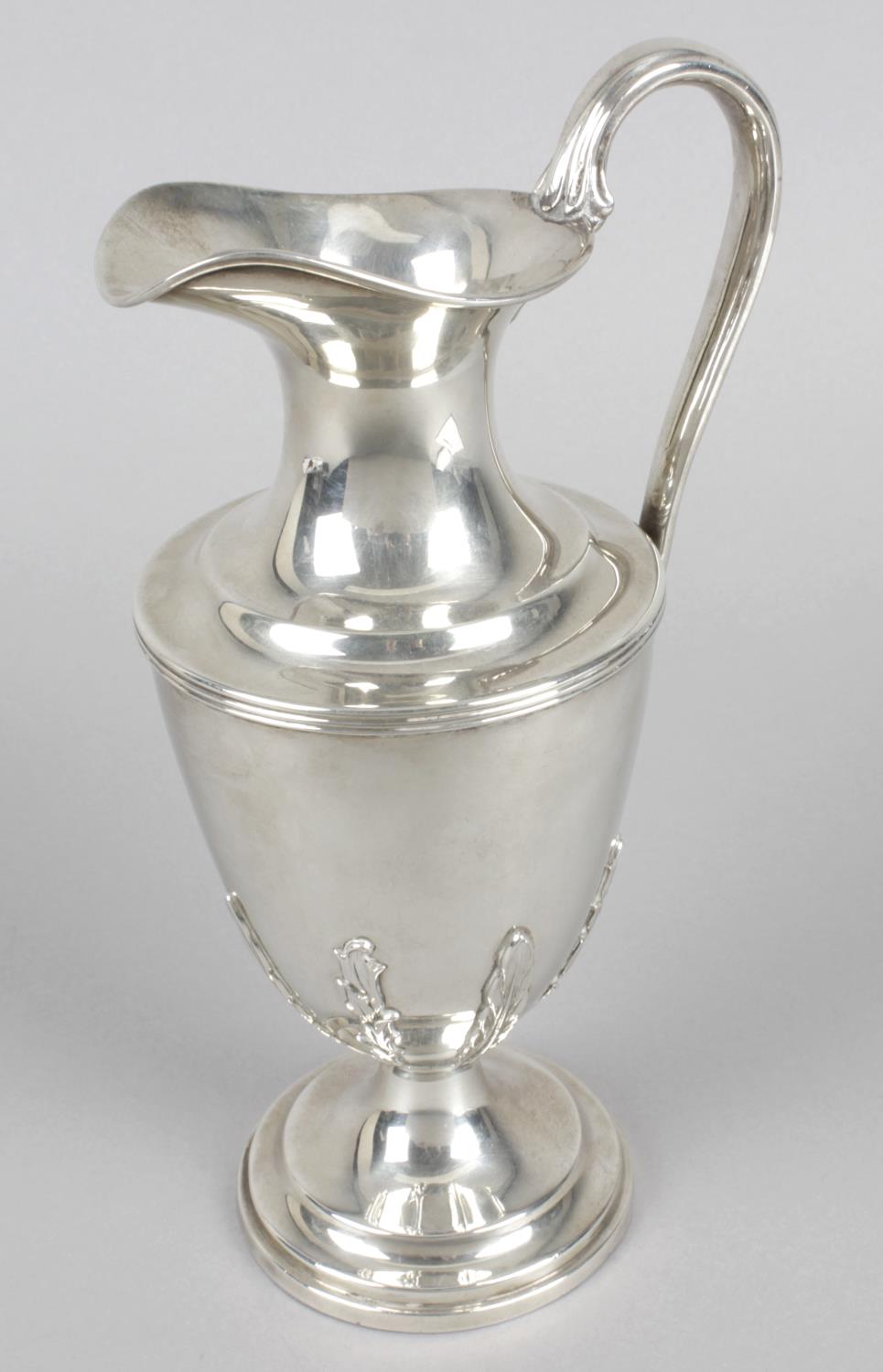 A modern silver claret jug,