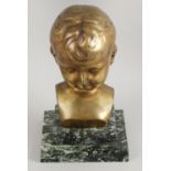 An early 20th century bronze head a shoulder bust modelled as a young boy upon a square,