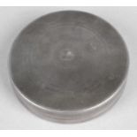 A plain circular box or dressing table pot.