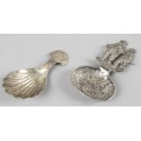 Two caddy spoons - one of continental design with two figures in seventeenth century dress as a