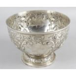 A Victorian silver rose bowl with raised decoration depicting swans,