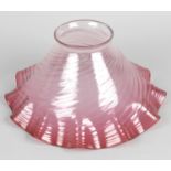 A cranberry glass oil lamp shade of frilled form,