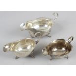 Three silver sauce boats - all of traditional style with loop handles and standing on three hoof