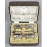 A cased set of four Edwardian silver open salts,