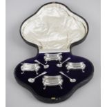 A cased set of four early George V silver open salts,