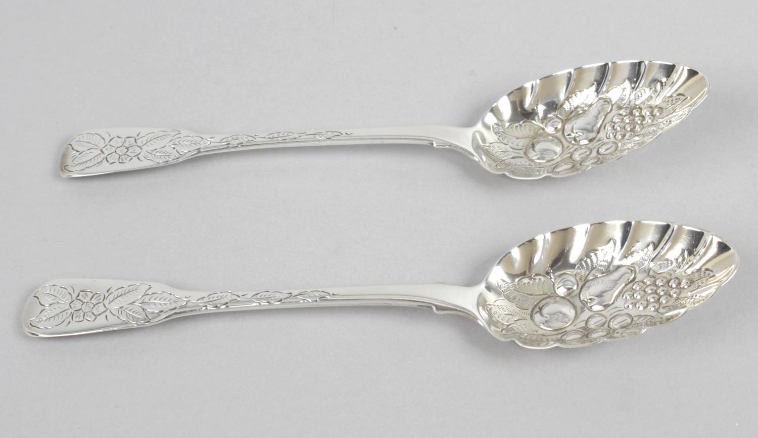 A matched pair of late George III silver 'berry' spoons,