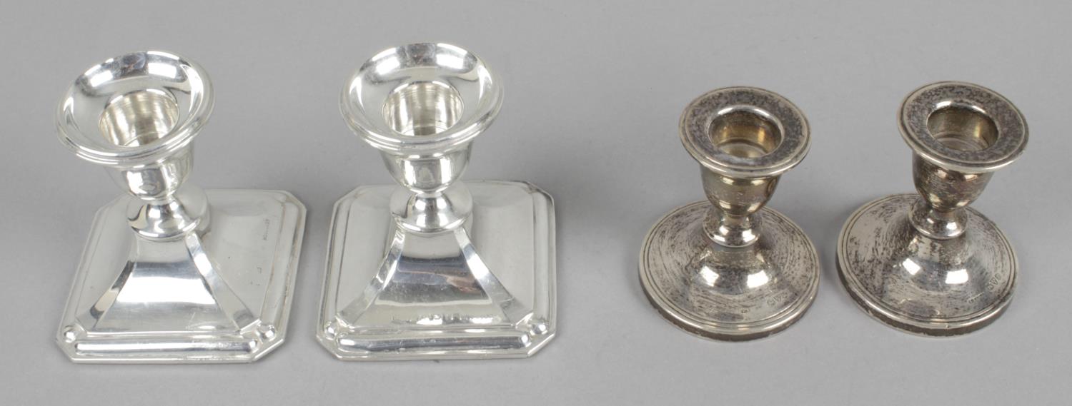 Two pairs of silver mounted dwarf candlesticks,