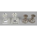 Two pairs of silver mounted dwarf candlesticks,