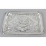 An Edwardian silver dressing table tray of rounded rectangular form,