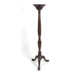 A carved mahogany torchère,