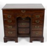 A George III mahogany kneehole desk or dressing table,