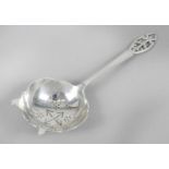 A 1940's silver tea strainer with pierced terminal,