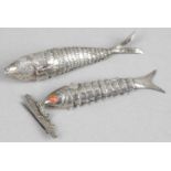 A small white metal articulated fish,