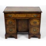 A reproduction walnut and mahogany crossbanded kneehole desk,