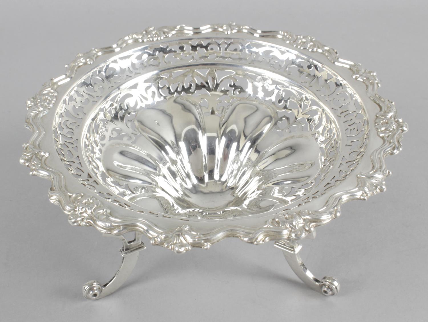 An Edwardian silver raised pierced bowl within an acanthus shaped rim and pierced floral decoration