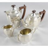 A mid-20th century silver four piece tea set of ovoid tapering shape with panel sides comprising