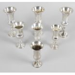 A set of three silver kiddush cups,
