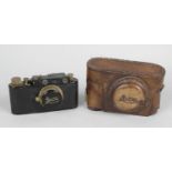 An early 20th century Leica-style camera, with original leather outer case.