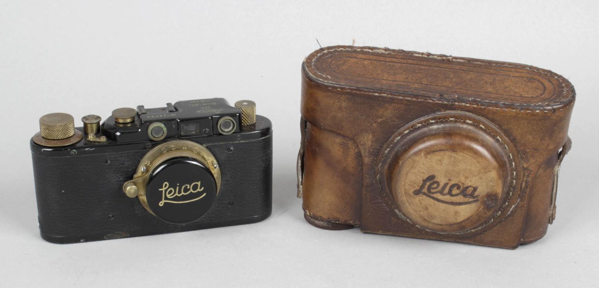 An early 20th century Leica-style camera, with original leather outer case.