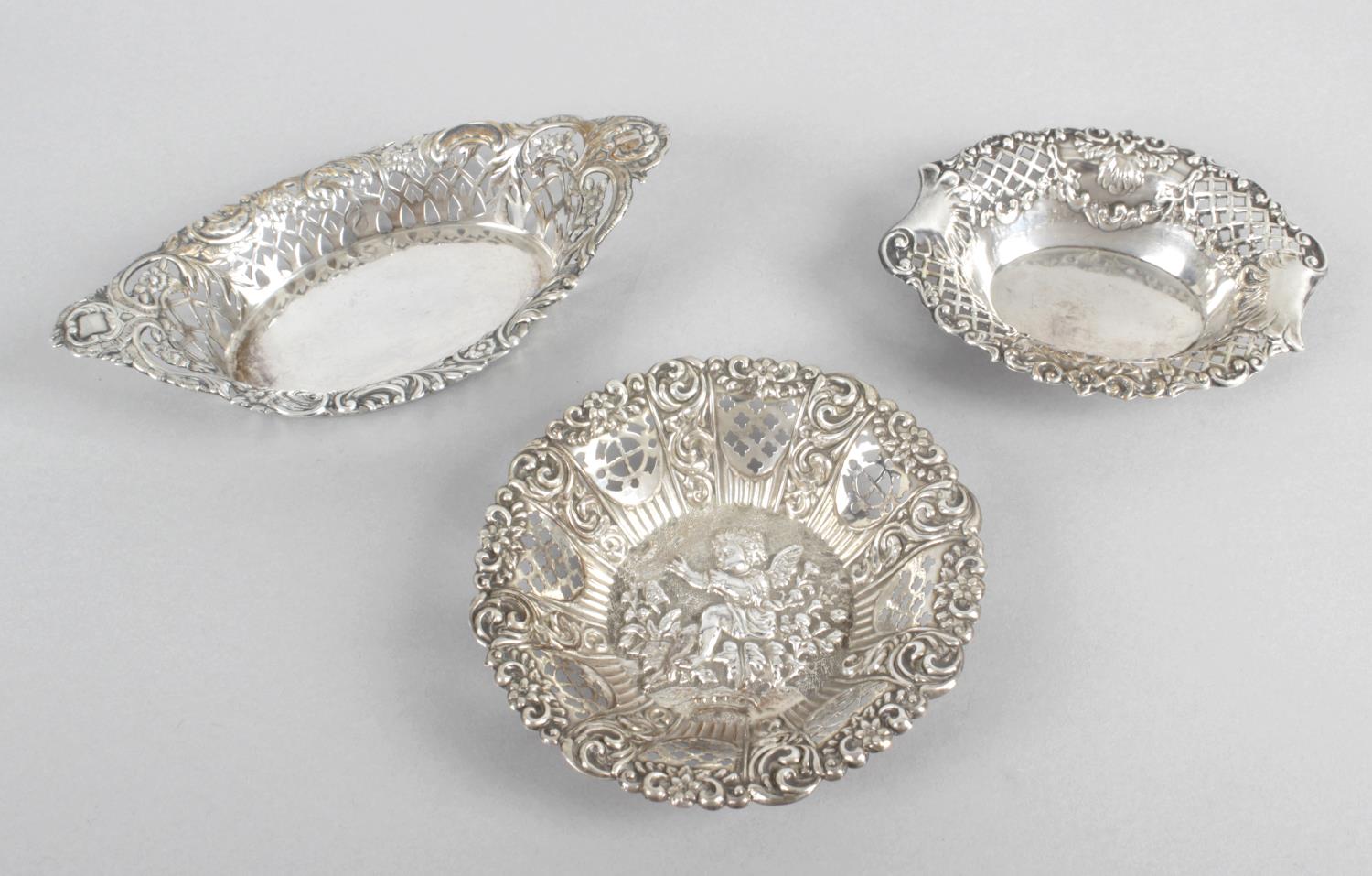 A selection of small pierced or embossed silver dishes,